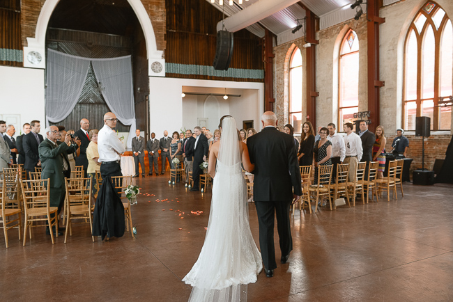 the bride's dad walks her down the aisle | photo: Photos by Kristopher | via https://emmalinebride.com