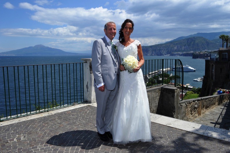 bride and groom stand in front of the Bay of Naples| Planner: Venice Events | via https://emmalinebride.com/real-weddings/italian-weddings-destination/