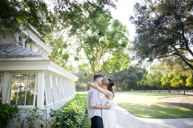 couple kiss outside greenhouse at Santa Fe Springs engagement session
