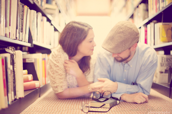couple holding hands in library engagement shoot