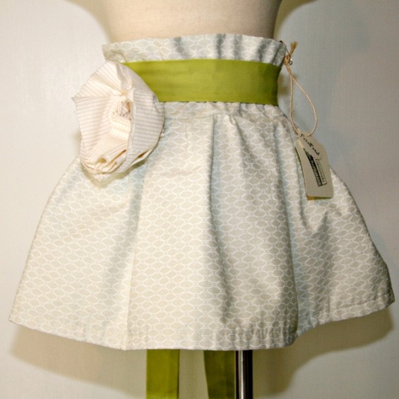 green flower girl skirt with pattern and large rose