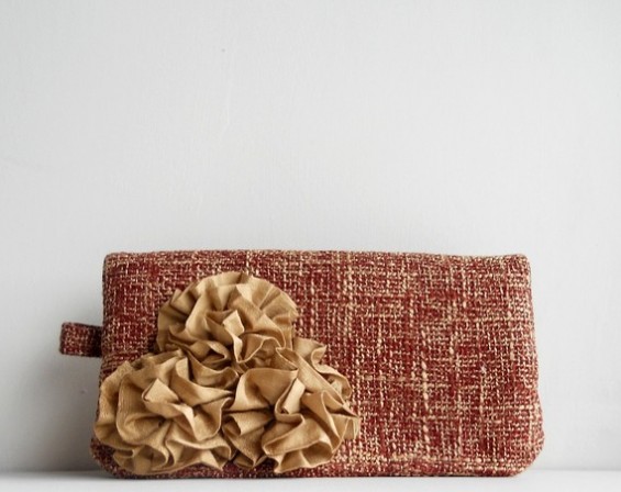 reddish orange clutch purse with rosettes