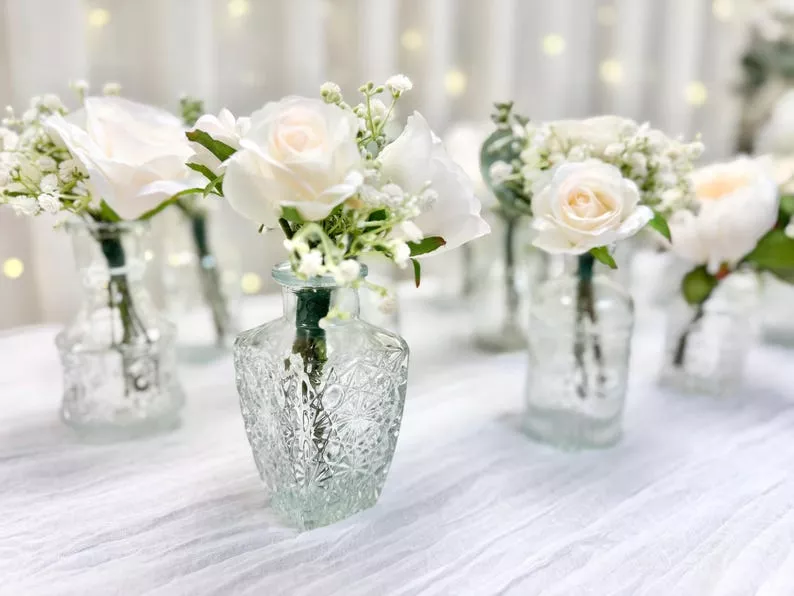 bud vases with white roses for wedding table decorations