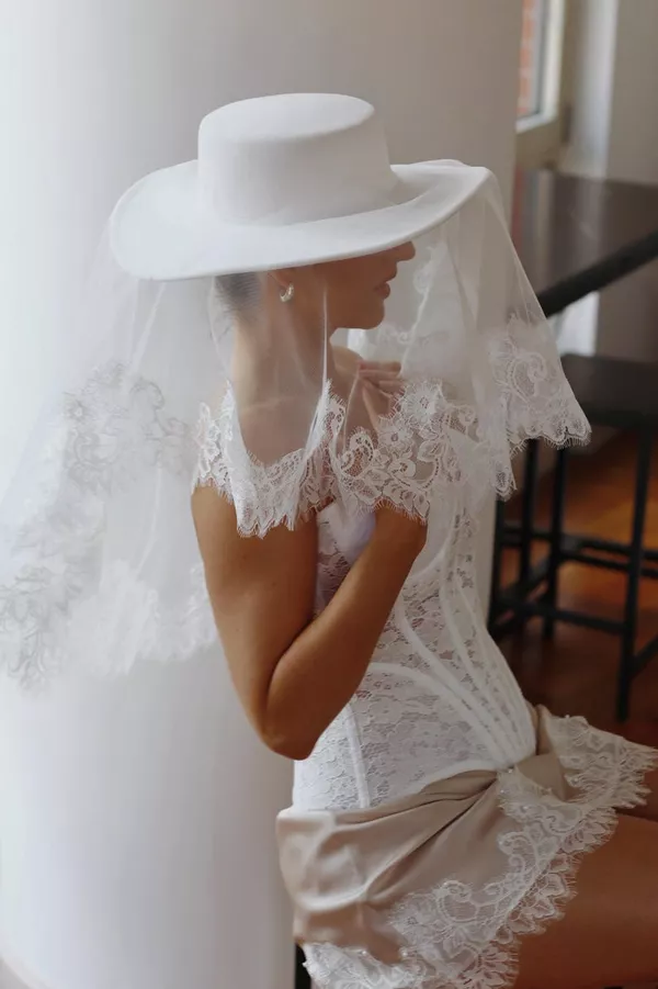bride wearing a wide brim hat as a wedding veil alternative