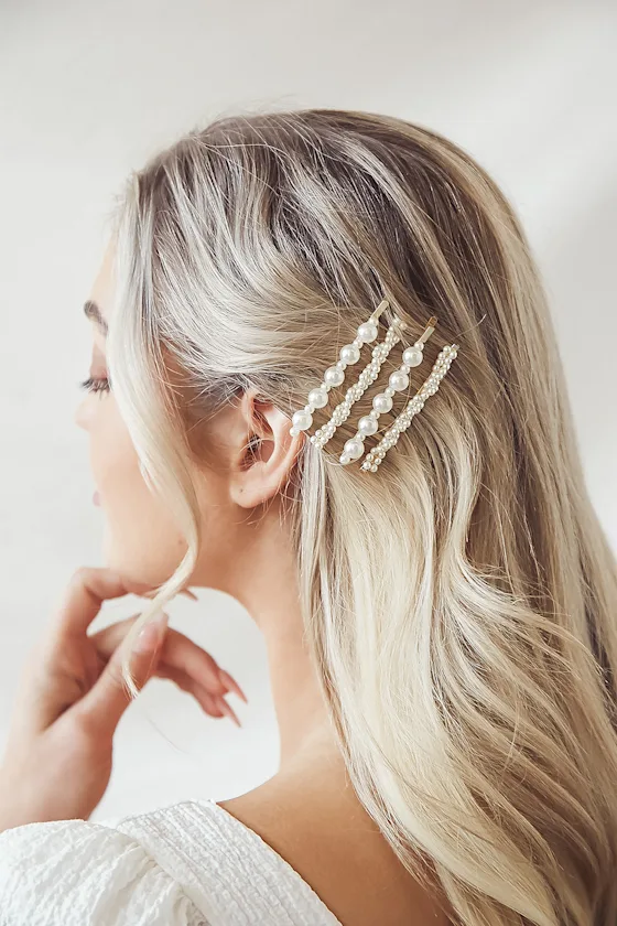 bride wearing gold and pearl wedding hair pins