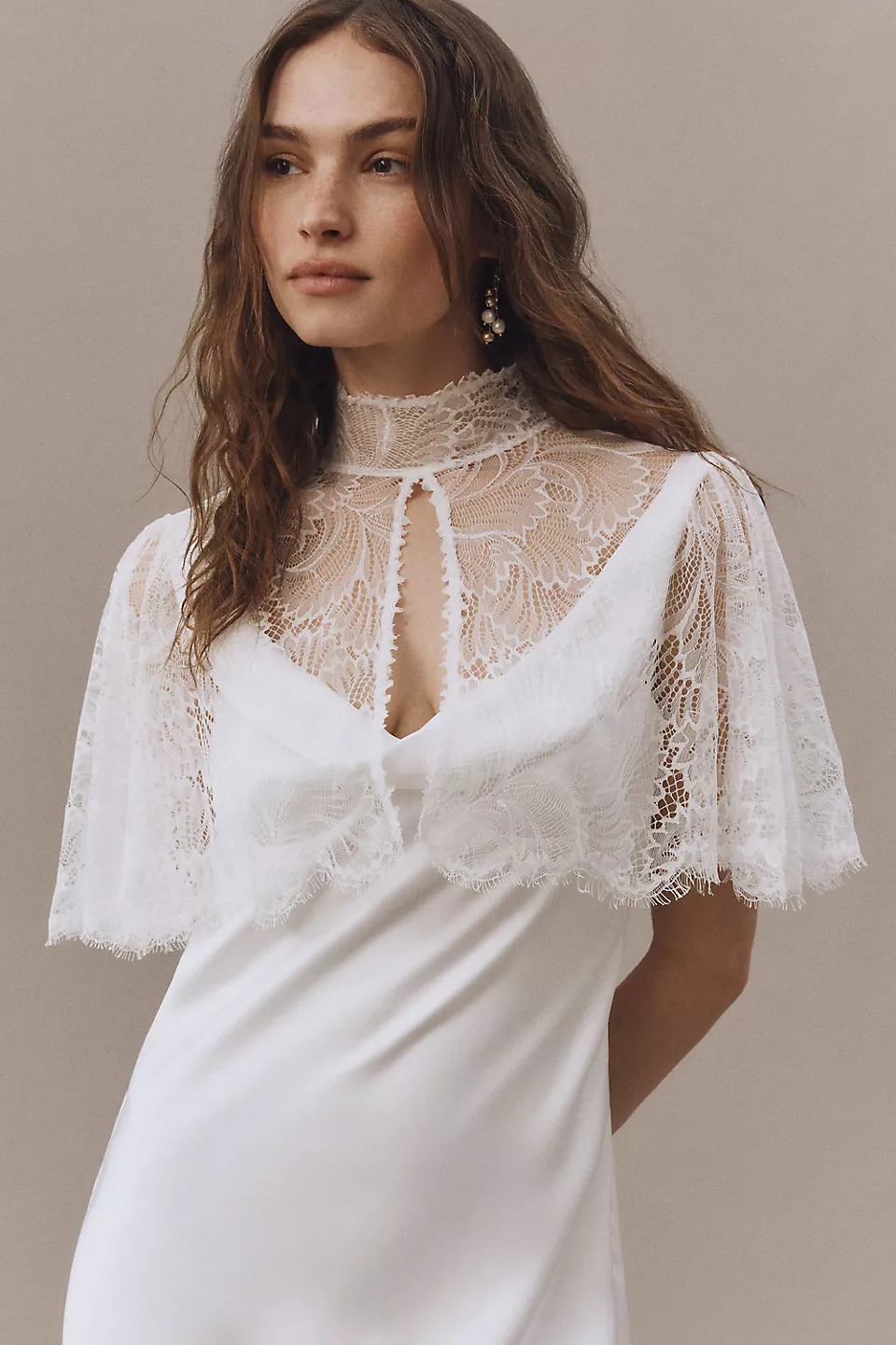 wedding veil alternative idea – bride wearing a short sleeve lace bridal cape instead of a wedding veil