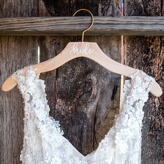 Bride wood dress hanger by Deighan Design | via Wood Themed Wedding Ideas: https://emmalinebride.com/themes/wood-themed-wedding-ideas/