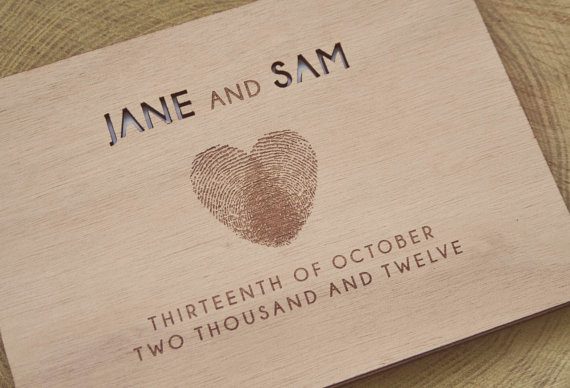 Wood guest book with fingerprints and personalized cover by Totally Salinda | via Wood Themed Wedding Ideas: https://emmalinebride.com/themes/wood-themed-wedding-ideas/