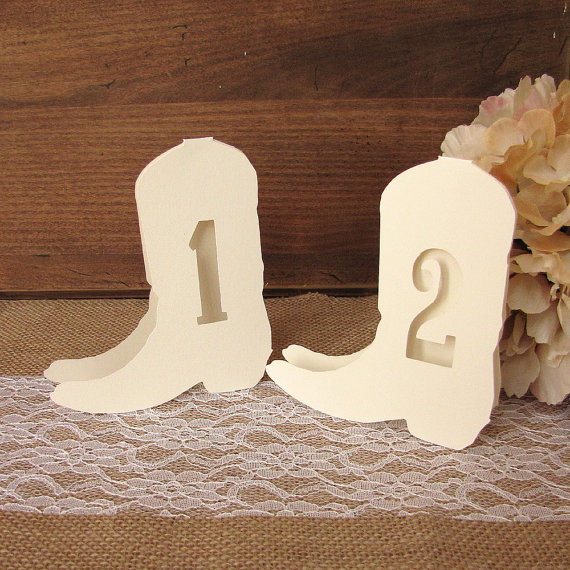 table numbers in shape of cowboy boots by dazzlingdaisiesco | barn reception ideas for weddings via https://emmalinebride.com/reception/barn-ideas-weddings/ ‎