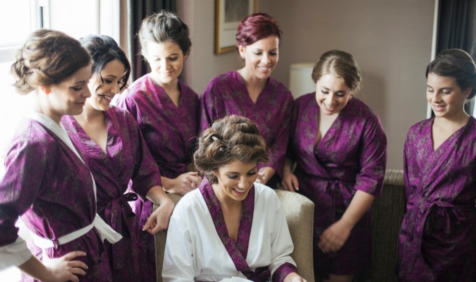 bridesmaids in robes with bride