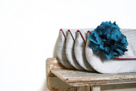 clutch purse with peacock blue flower | bridesmaid clutches instead of flowers via https://emmalinebride.com/bridesmaid/clutches-instead-of-flowers/