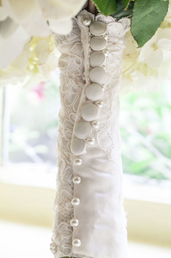buttons and pearls bouquet wrap | photo: riverland studios | wedding bouquet wraps: https://emmalinebride.com/bouquets/wedding-bouquet-wraps/