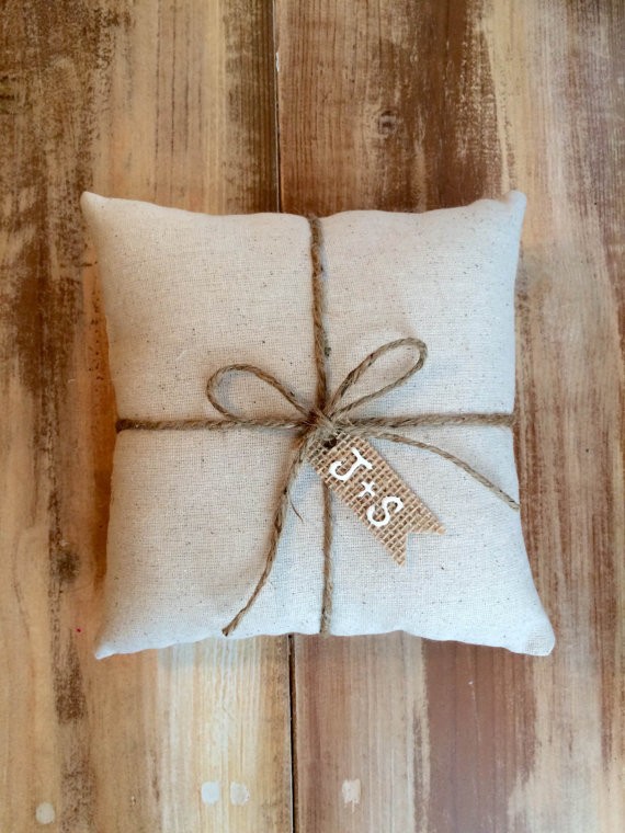 natural cotton ring bearer pillow with burlap tag initials | 41 Beautiful Rustic Ring Pillows on Etsy | https://emmalinebride.com/rustic/ring-pillows-etsy-weddings/