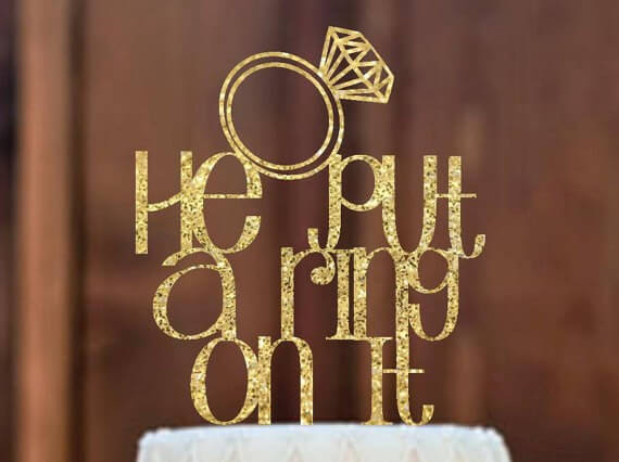 he put a ring on it cake topper by mommygottalent | via 21 Totally Fun Ring Themed Bridal Shower Ideas → https://emmalinebride.com/planning/ring-themed-bridal-shower/