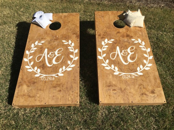 custom wedding cornhole boards by StarsStripesSawdust via 26 Things Guests Love at Weddings from A to Z | https://emmalinebride.com/planning/things-guests-love-at-weddings/