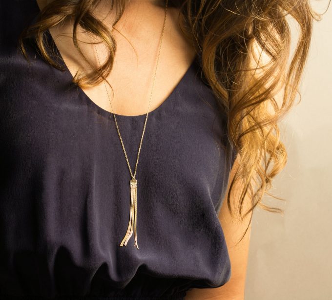 Long gold tassel necklace by Layered and Long via 21 Festive Tassel Wedding Decorations & Accessories | https://emmalinebride.com/themes/tassel-wedding-decorations/