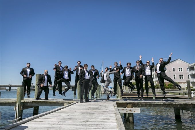 groom and groomsmen jump in this fun photograph in this Crystal Coast Wedding | North Carolina wedding photographed by Ellen LeRoy Photography - https://emmalinebride.com/real-weddings/breathtaking-crystal-coast-wedding-mara-will-married/