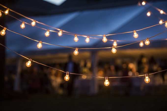 outdoor lighting at reception in this Crystal Coast Wedding | North Carolina wedding photographed by Ellen LeRoy Photography - https://emmalinebride.com/real-weddings/breathtaking-crystal-coast-wedding-mara-will-married/