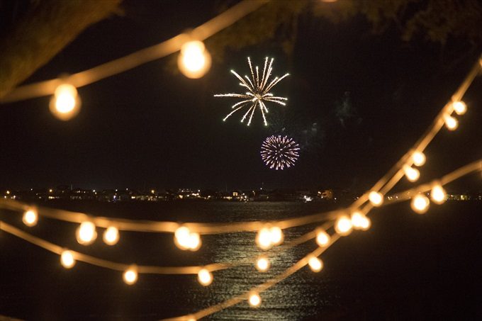 fireworks over the water in this Crystal Coast Wedding | North Carolina wedding photographed by Ellen LeRoy Photography - https://emmalinebride.com/real-weddings/breathtaking-crystal-coast-wedding-mara-will-married/