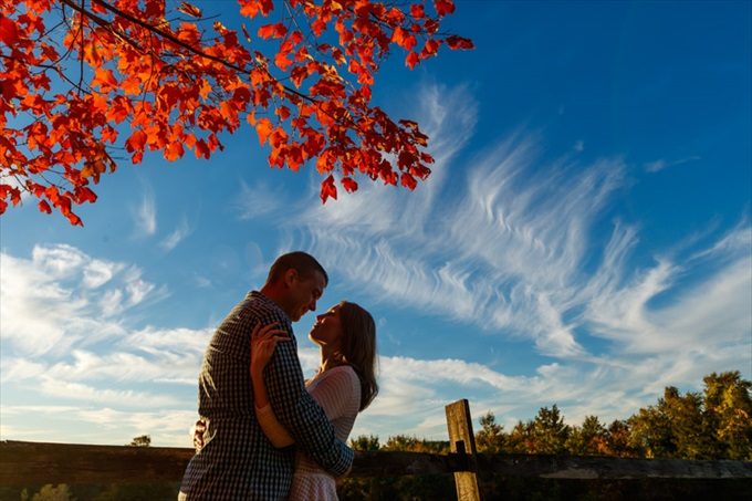couple kisses under blue skies during fall engagement session| engagement photography by Butler Photography LLC.| Love Fall Weddings? See this Somers, CT Engagement Session - https://emmalinebride.com/real-weddings/love-the-fall-weddings-see-this-somers-ct-engagement-session/
