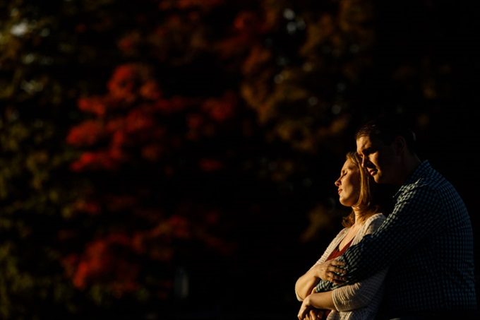 engaged couple embrace under sunset during engagement session| engagement photography by Butler Photography LLC.| Love Fall Weddings? See this Somers, CT Engagement Session - https://emmalinebride.com/real-weddings/love-the-fall-weddings-see-this-somers-ct-engagement-session/