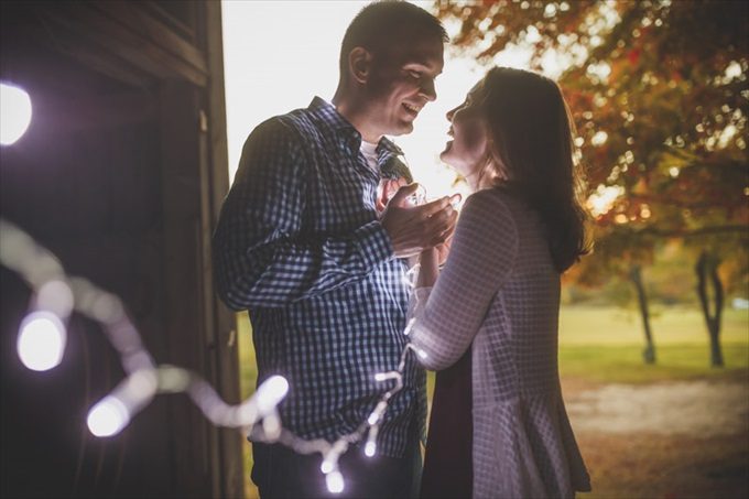 couple holds string lights during fall engagement session | engagement photography by Butler Photography LLC.| Love Fall Weddings? See this Somers, CT Engagement Session - https://emmalinebride.com/real-weddings/love-the-fall-weddings-see-this-somers-ct-engagement-session/