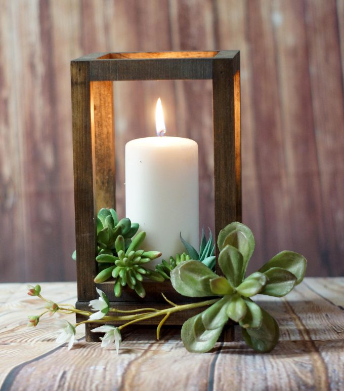 wedding centerpiece with succulents and candle lantern