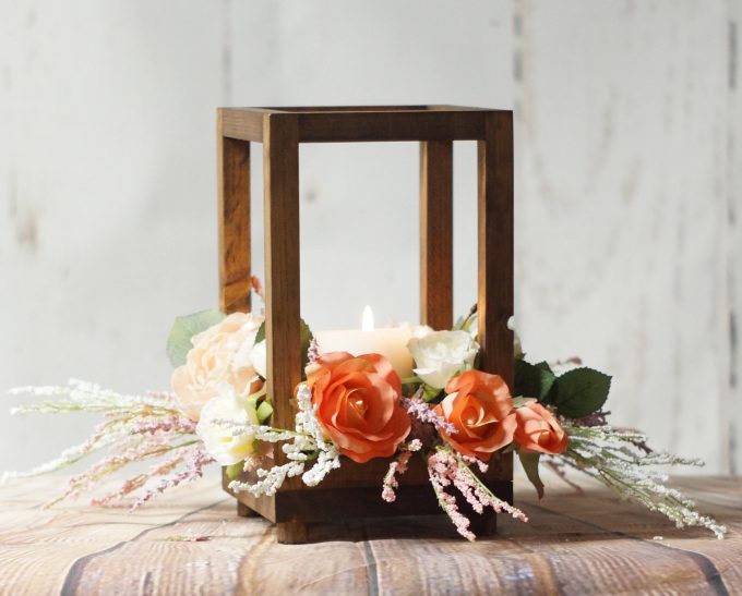 wood lantern centerpiece with flowers to use as a centerpiece