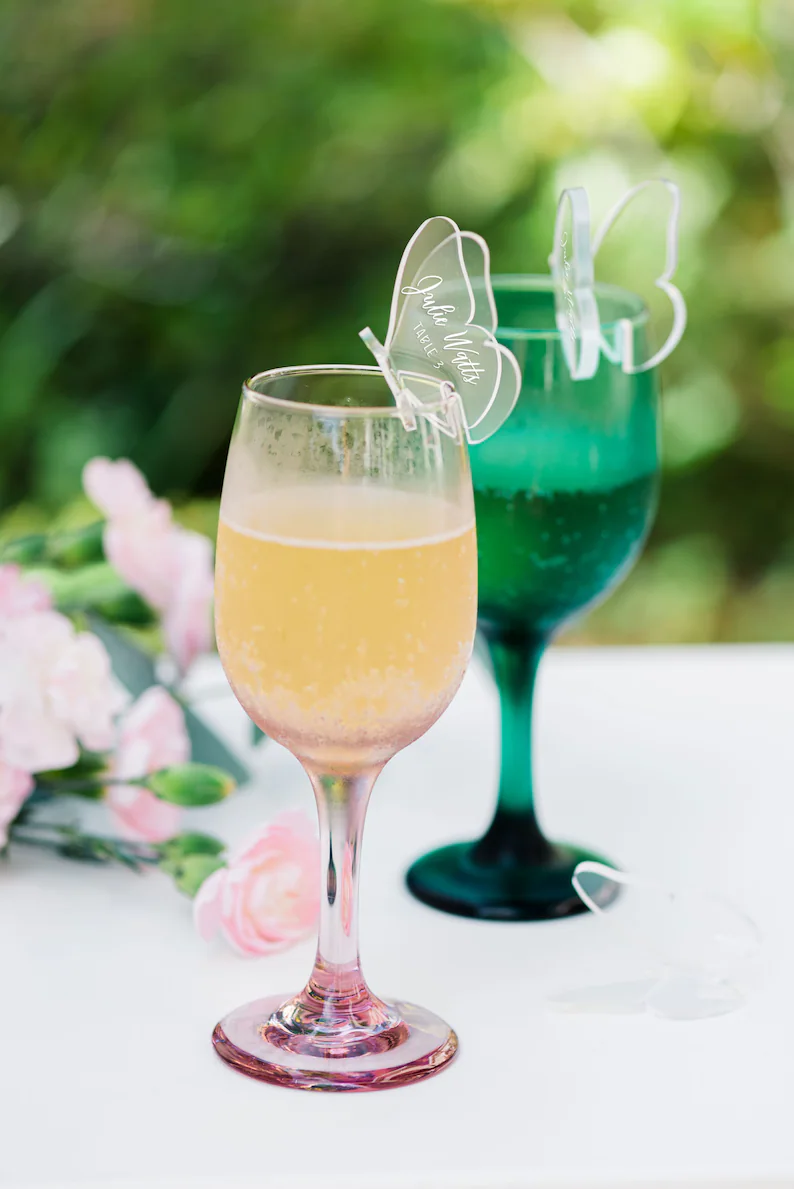 Clear butterfly place cards that sit on drinking glass