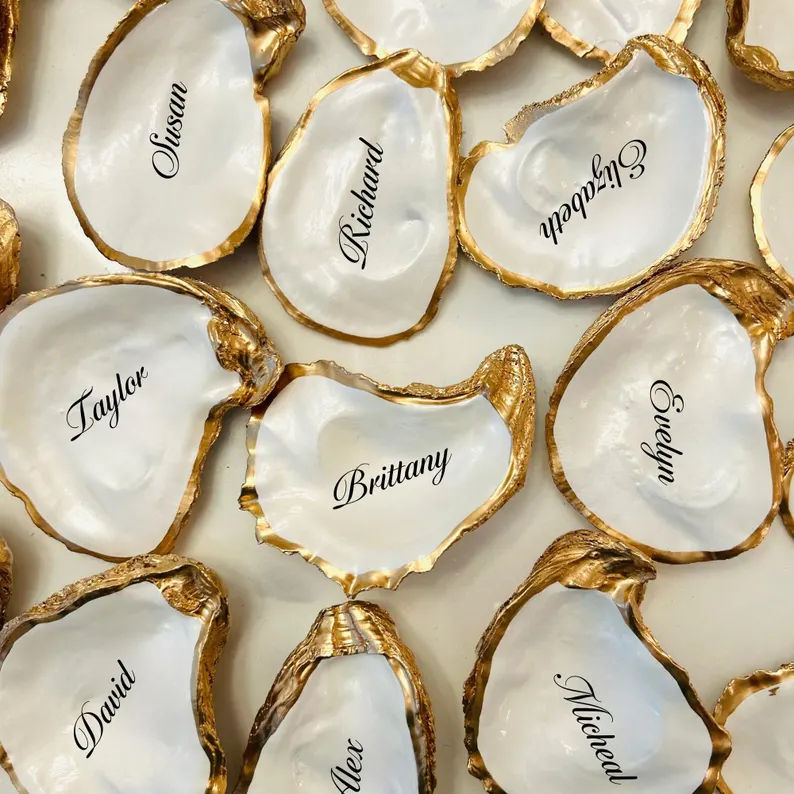 Oyster shell place cards personalized with guest names