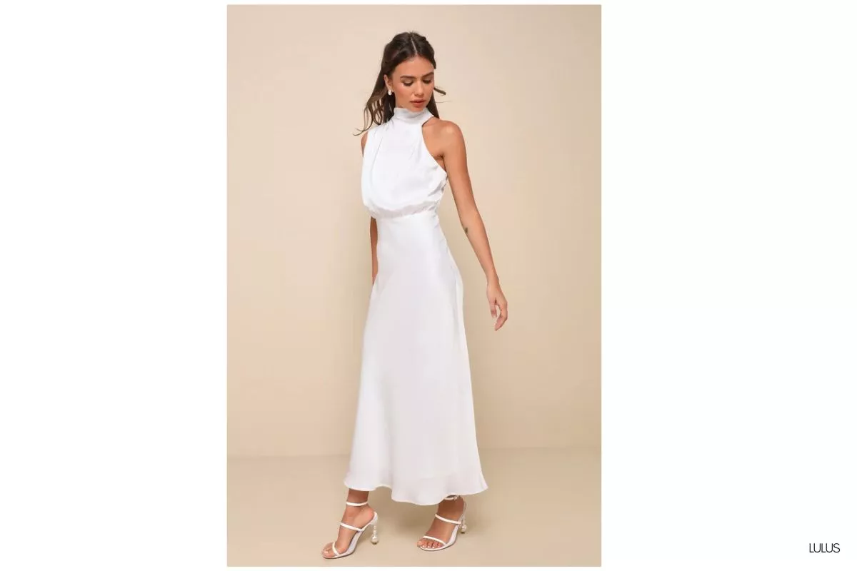 bride wearing a second dress for wedding reception in a short white mini dress dancing at reception