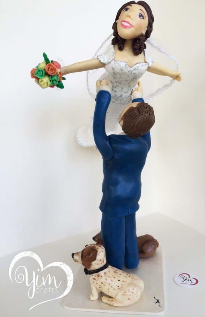 bride lifted by groom cake topper