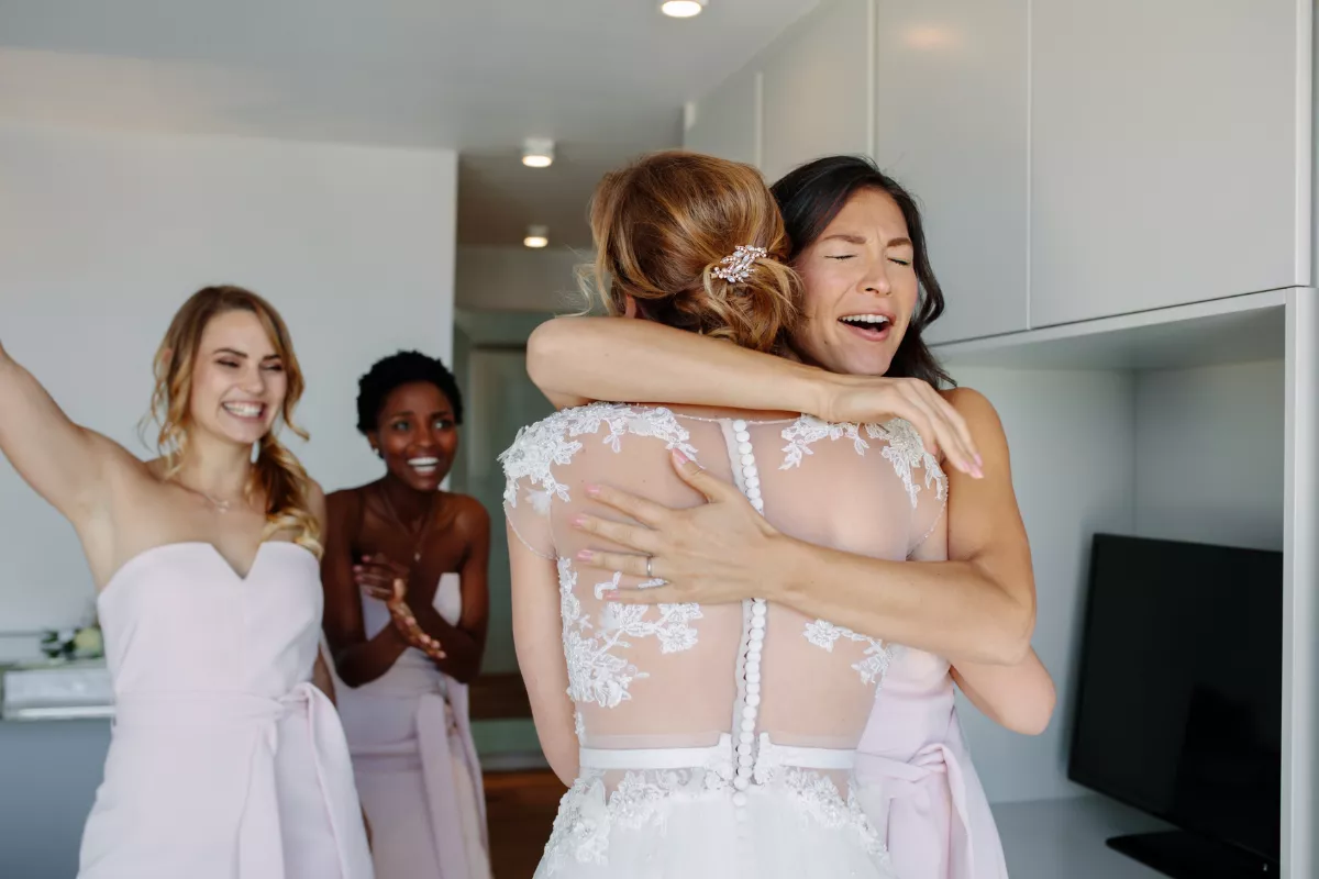 bride giving a thoughtful maid of honor gift to her best friend before the wedding