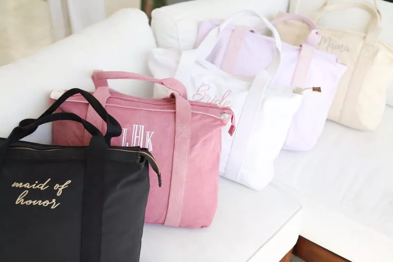 bridesmaid tote bags in black, pink, white, and yellow