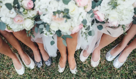 bridesmaids wearing matching fuzzy bridesmaid slippers while getting ready for wedding