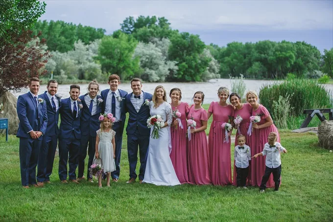Bridesmaid dresses in pink paired with navy suit for wedding