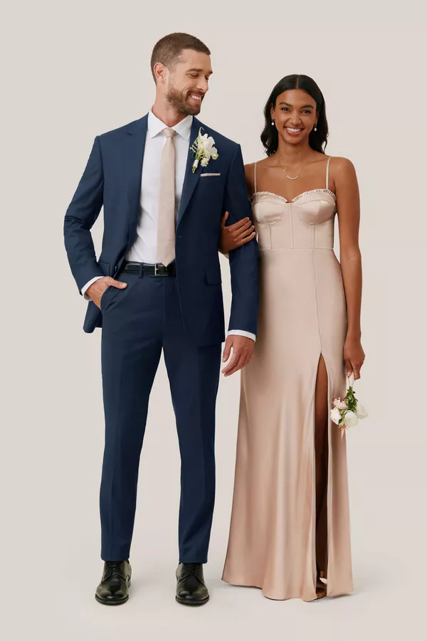 Metallic gold bridesmaid dress paired with navy wedding suit