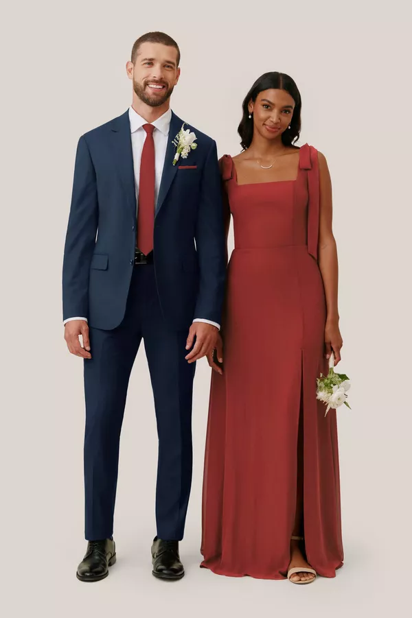 Terracotta bridesmaid dress paired with navy wedding suit