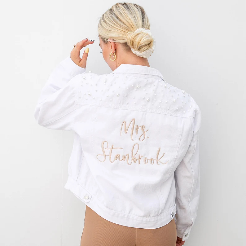 white bridal denim jacket worn on bride