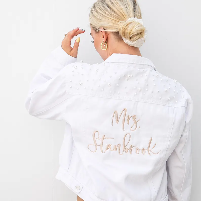 white cropped bridal denim jacket styled over wedding dress