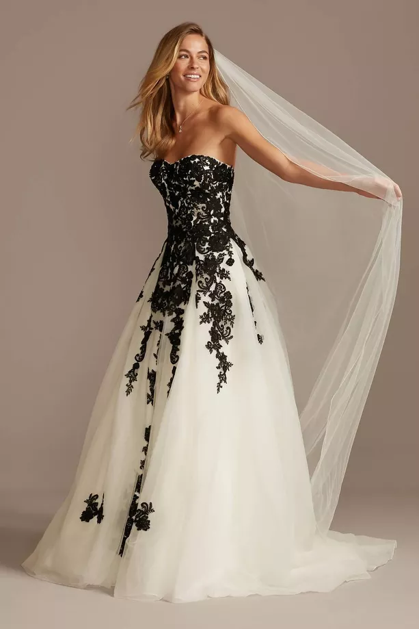 wedding dress that is black and white with lace and tulle