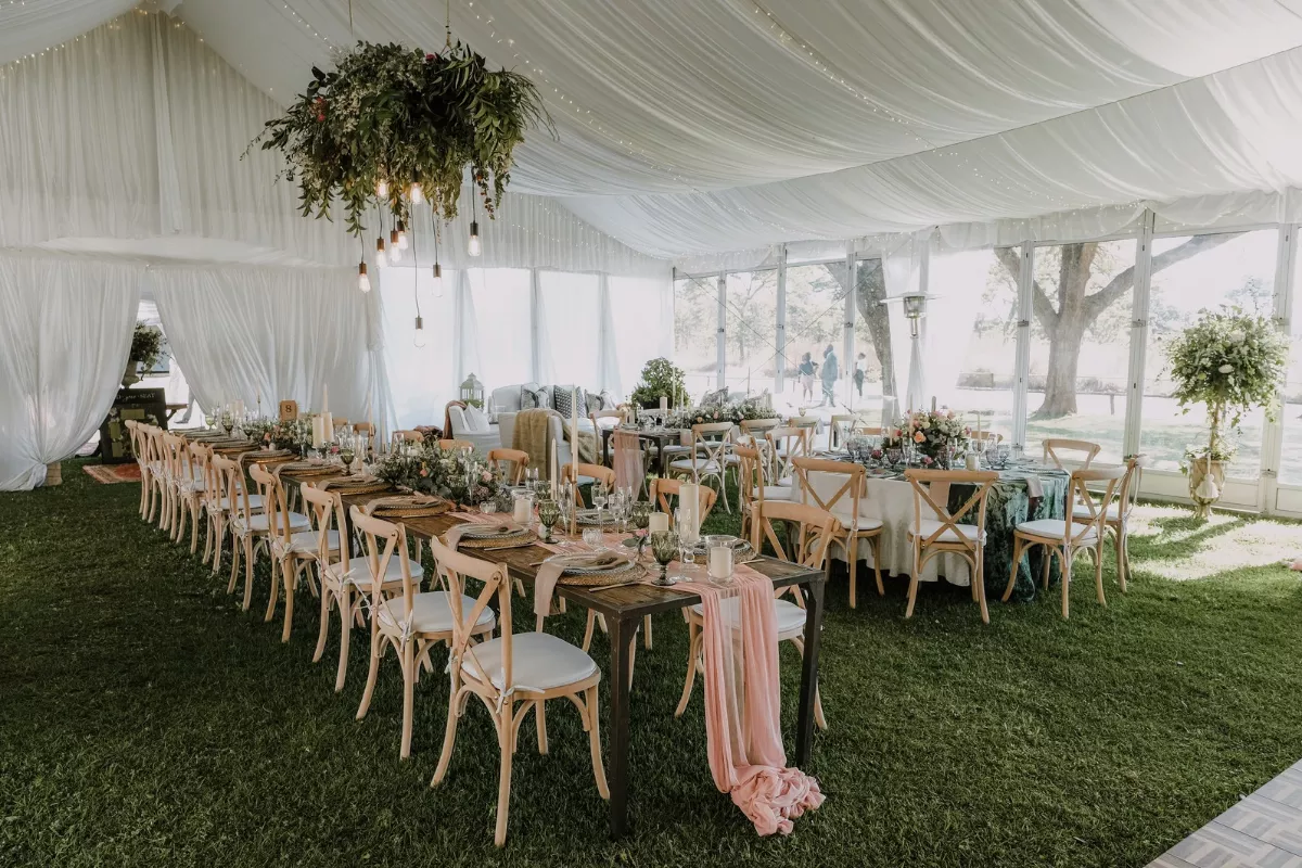 Enclosed wedding tent with sidewalls to protect guests from chilly wind