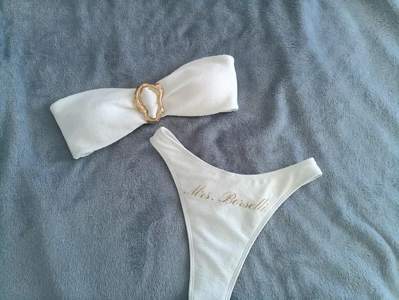 white bridal swimsuit with gold metal detail