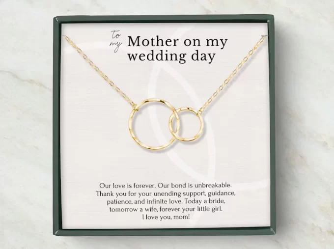 two reings entwined on a necklace to symbolize the unbreakable bond between mother and daughter