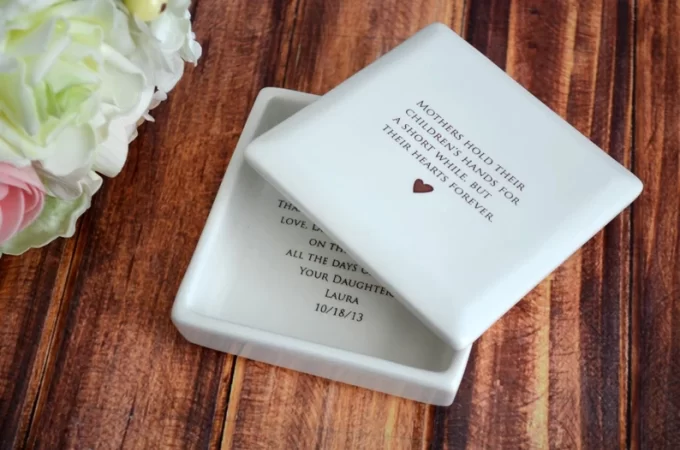 a square jewelry box that has mothers hold their children's hands for a short while keepsake memento message on it