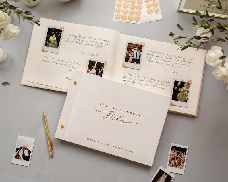 Polaroid wedding guest book station with instant camera, guest photo album, and handwritten notes at wedding reception