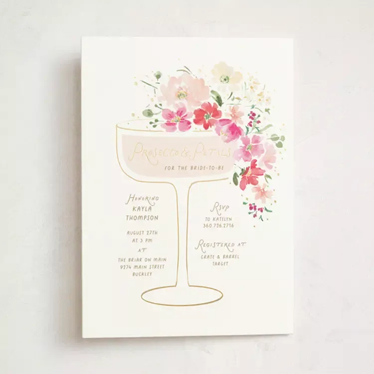 Elegant Prosecco and Petals bridal shower setup with champagne flutes, floral arrangements, and soft pink petals on tables