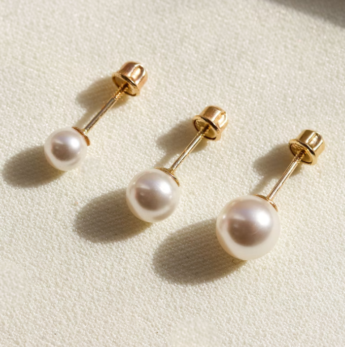 three pairs of pearl stud earrings in different sizes