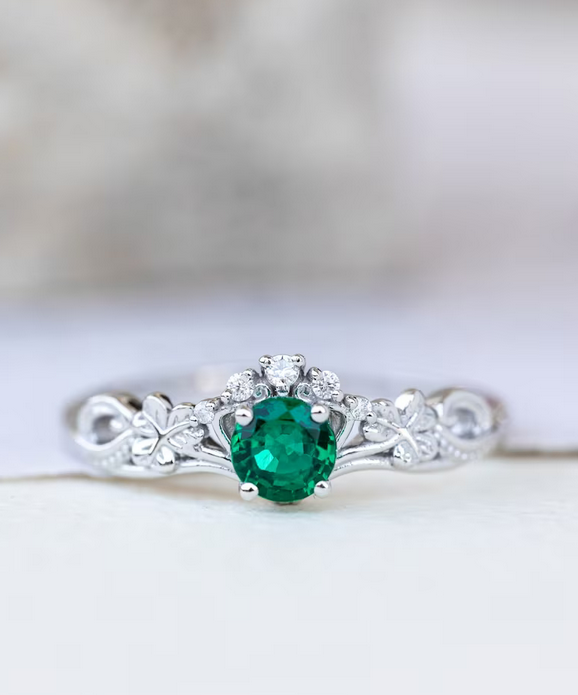 white gold clover leaf engagement ring with emerald stone