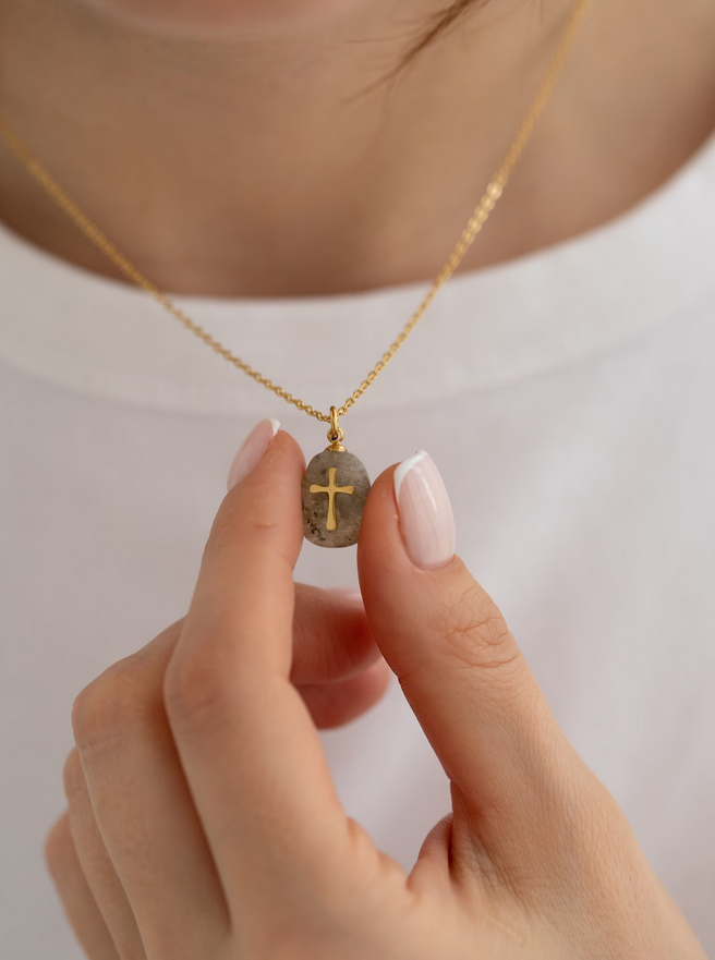 cross necklace on stone